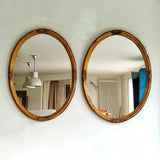 Paire de miroirs ovales anciens bois doré
